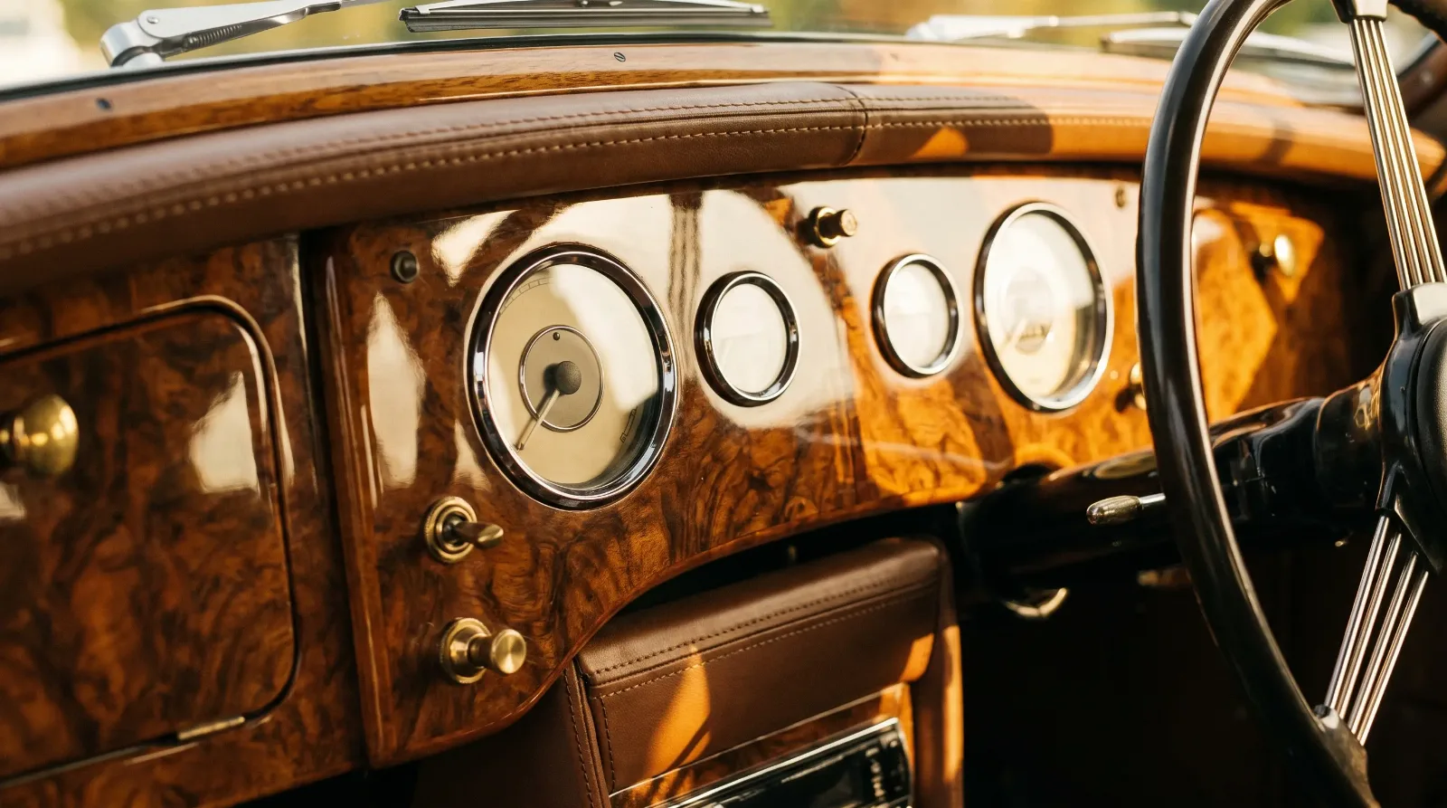 Walnut burl veneer dashboard with chrome-bezel gauges