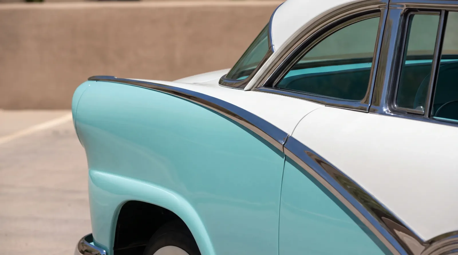 Two-tone 1950s luxury car body split by a chrome spear