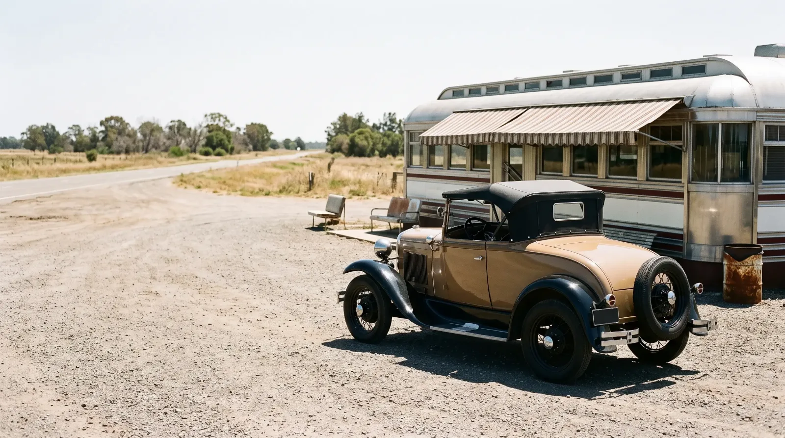 1930 Ford Model A roadster parked outside a roadside diner at noon