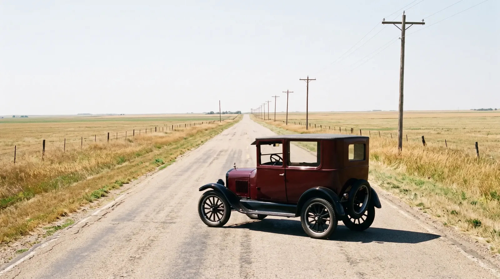 1926 Ford Model T Tudor sedan in maroon on an empty country road