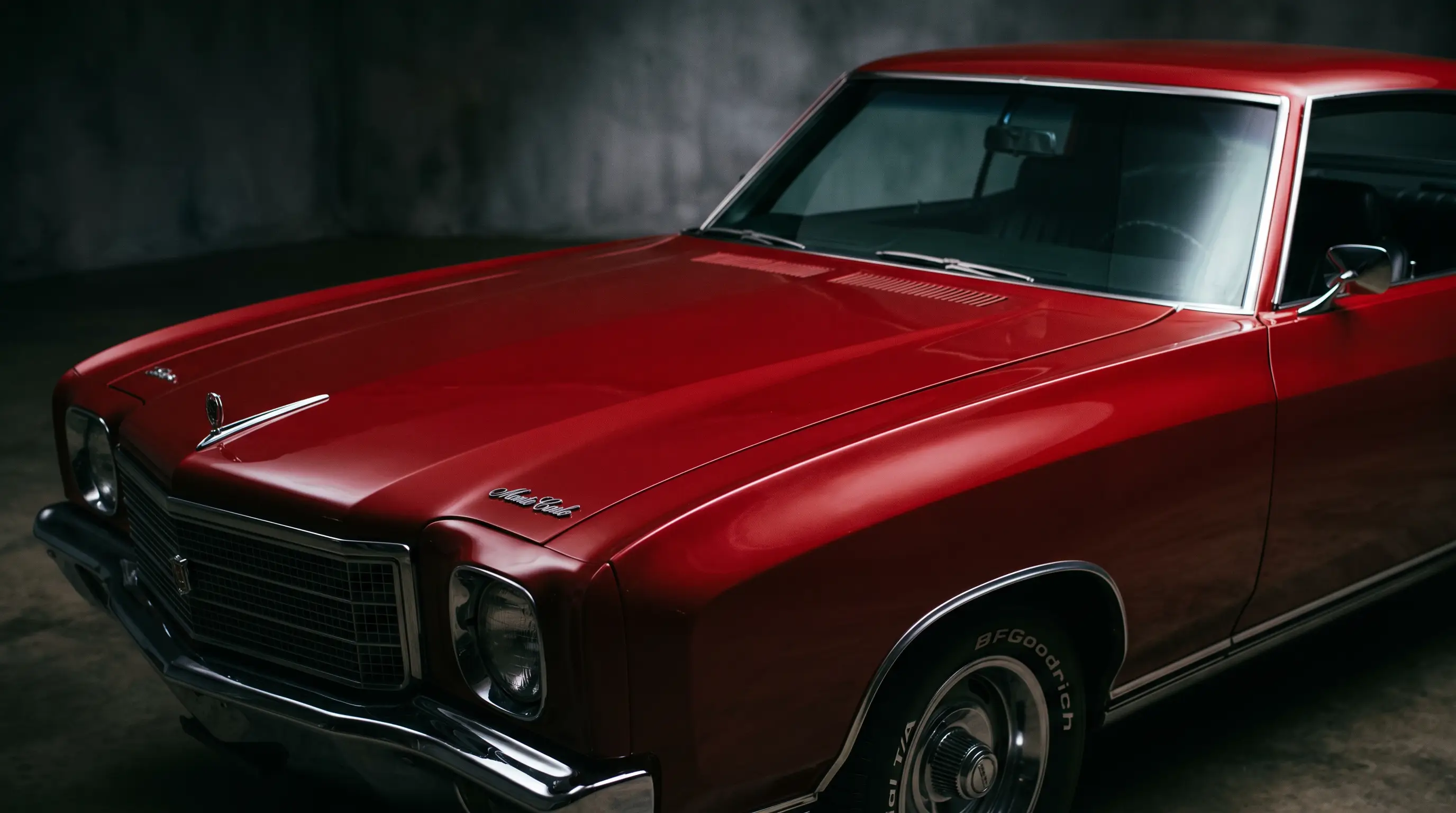 Close up of deep red 1970 Monte Carlo hood crown and Coke bottle body flanks