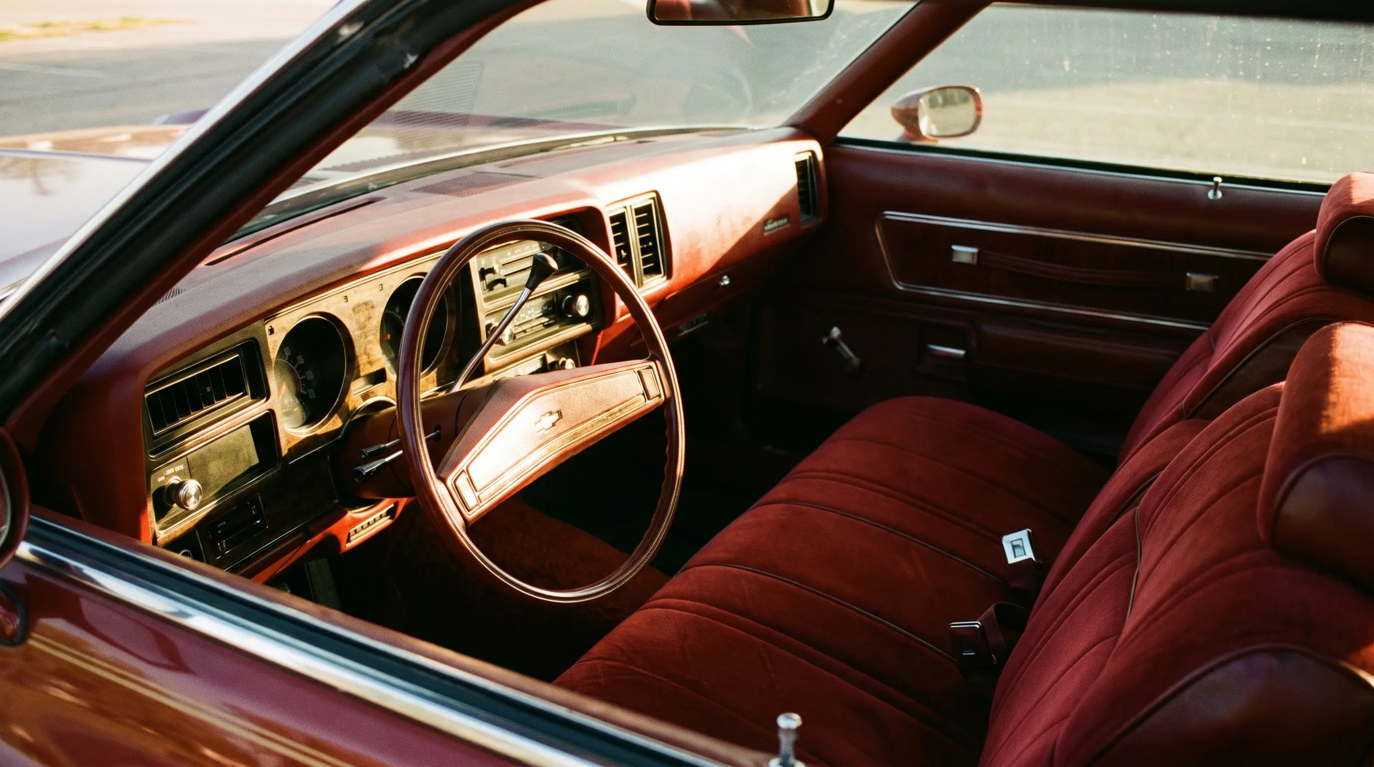 Curved dashboard and velour seats inside a 1973 Chevrolet Monte Carlo Colonnade coupe