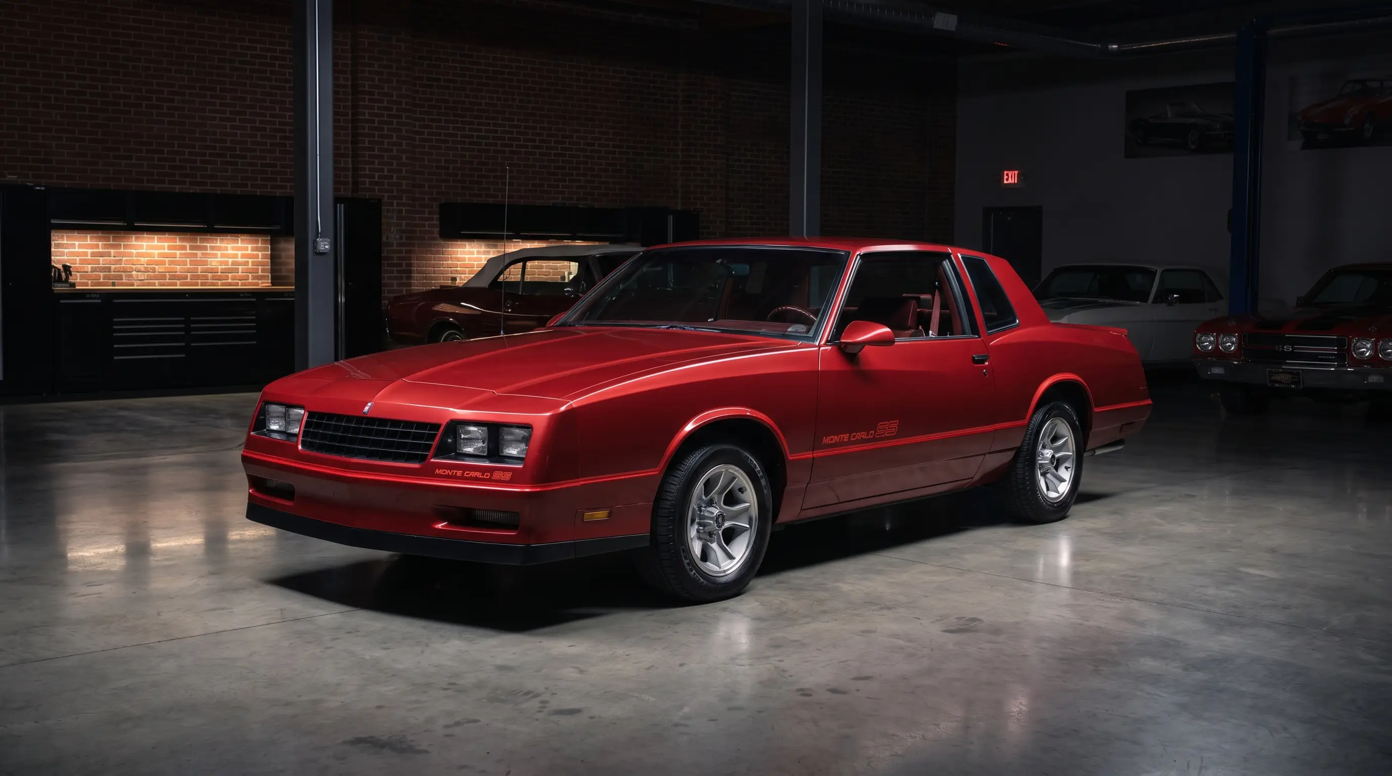 Red 1986 Chevrolet Monte Carlo SS in a spotlit private collector garage