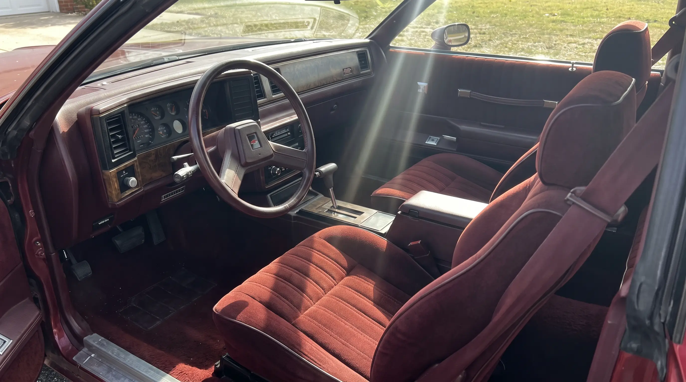 Bolstered bucket seats and gauge cluster inside a 1986 Monte Carlo SS cockpit