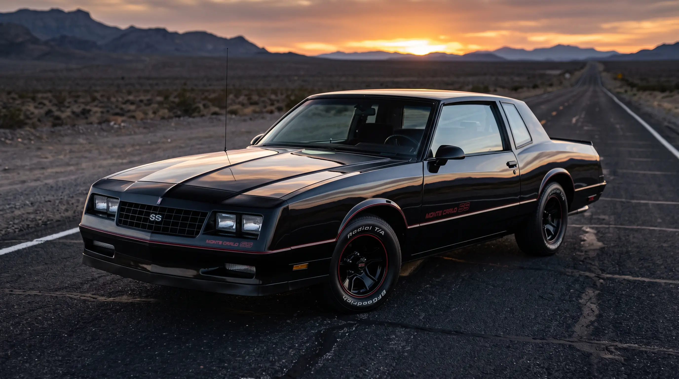 Black 1986 Monte Carlo SS on empty highway asphalt at dusk