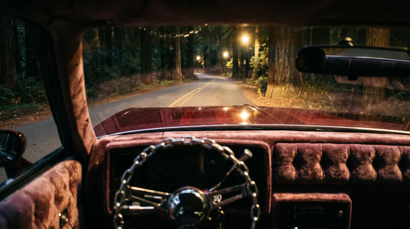 1985 Chevrolet Monte Carlo lowrider — chain wheel and velvet dash on a forest road