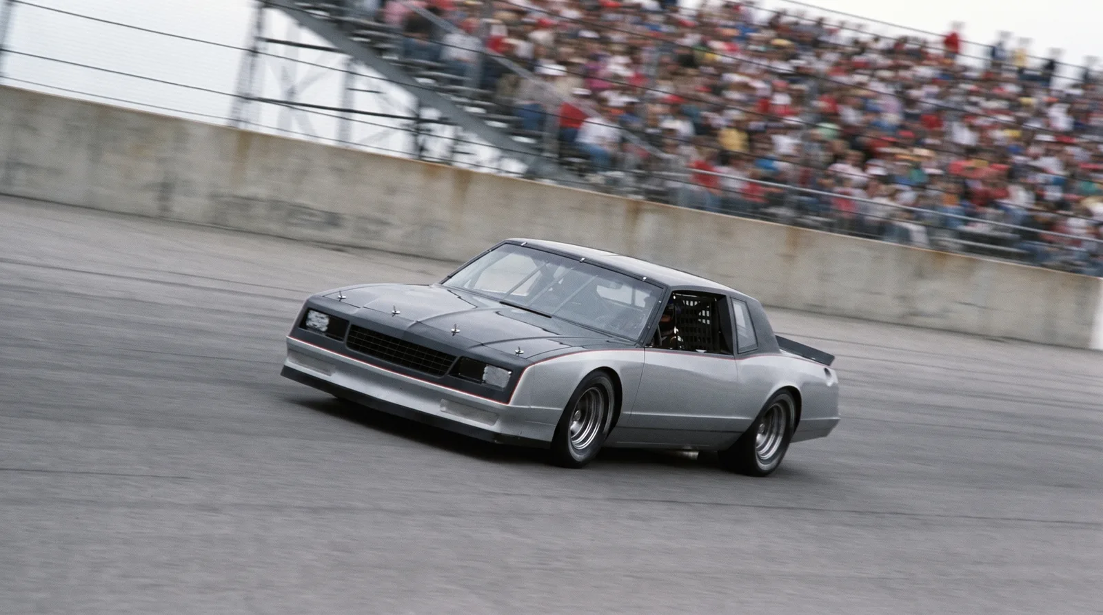 1985 Chevrolet Monte Carlo SS NASCAR stock car — panning through the banking