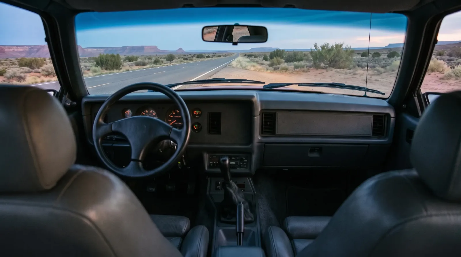 1986 Ford Mustang SVO, cabin and five-speed shifter at desert dusk