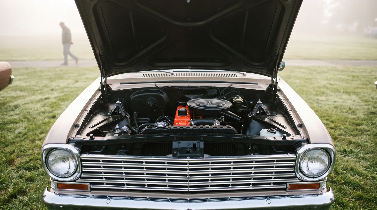 1962 Chevy II 153 four-cylinder — hood up on a misty show lawn