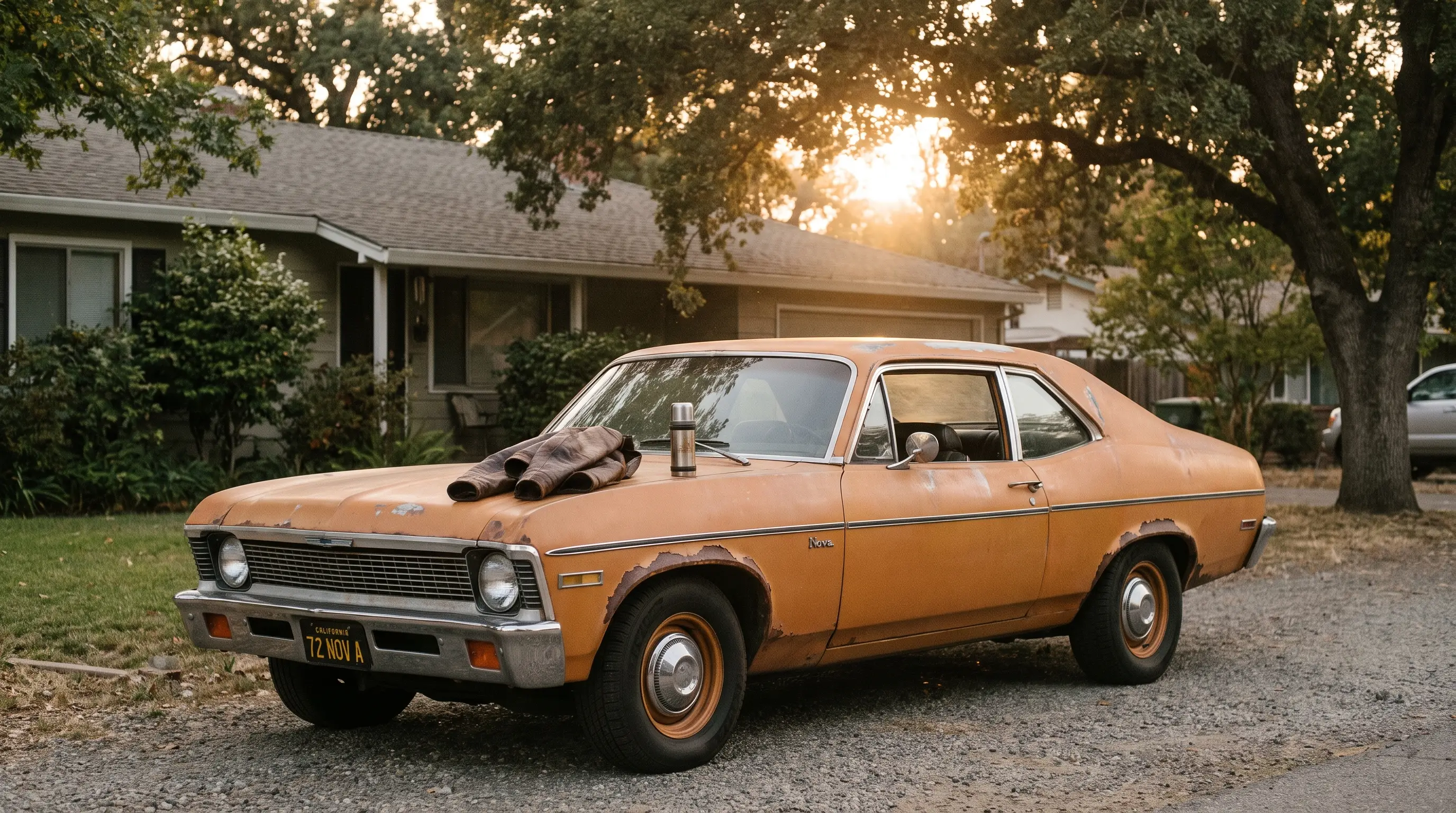 Weathered 1972 Chevy Nova parked in a quiet driveway in soft afternoon light