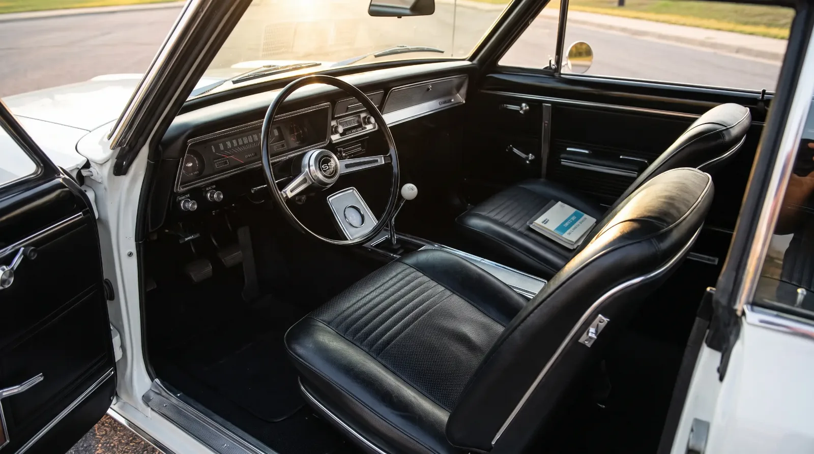 1966 Chevrolet Nova SS interior with black vinyl bucket seats and column-shift three-speed