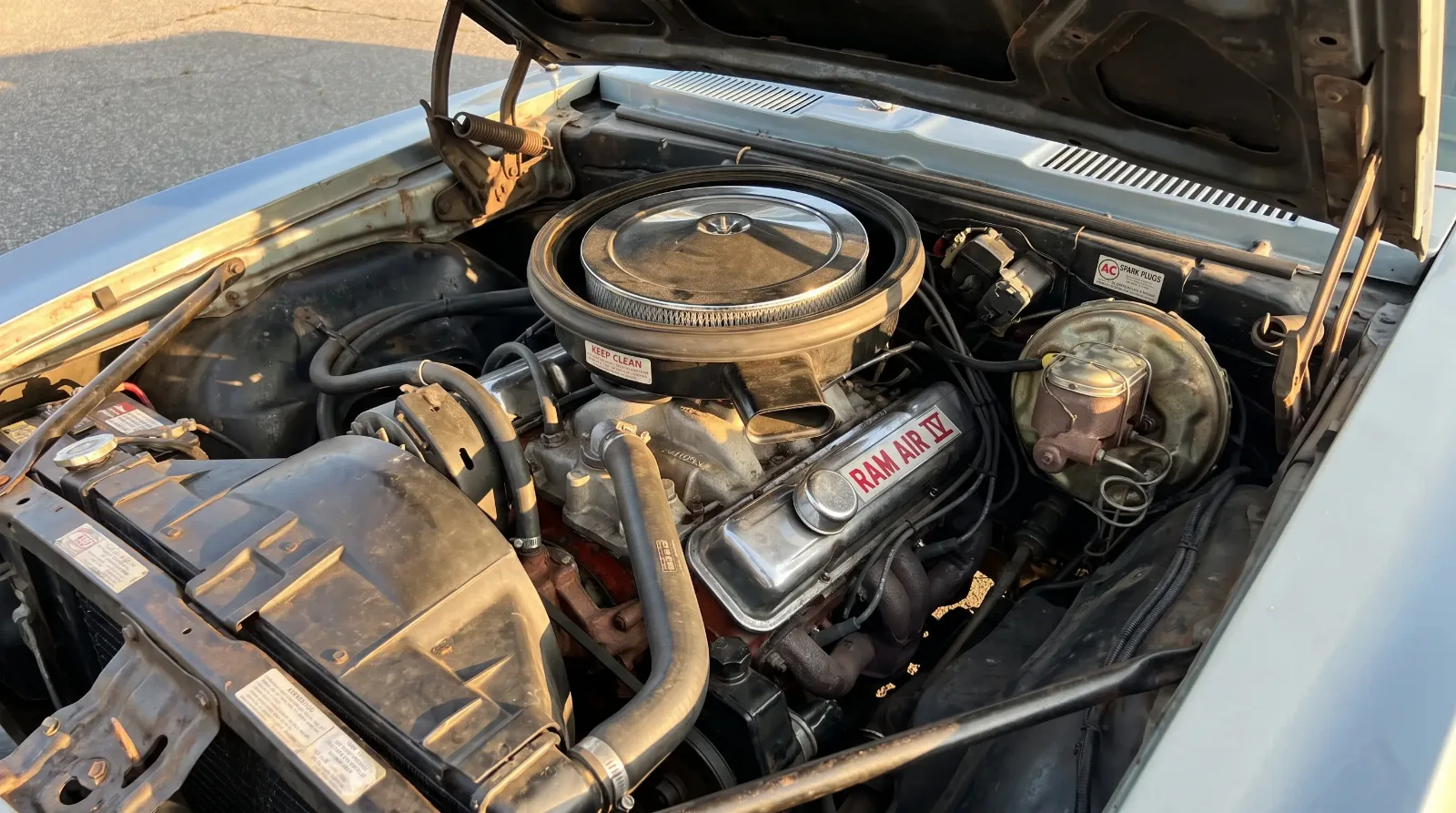 Ram Air IV 400 V8 engine bay detail in a Pontiac Firebird showing round-port heads and hood scoop