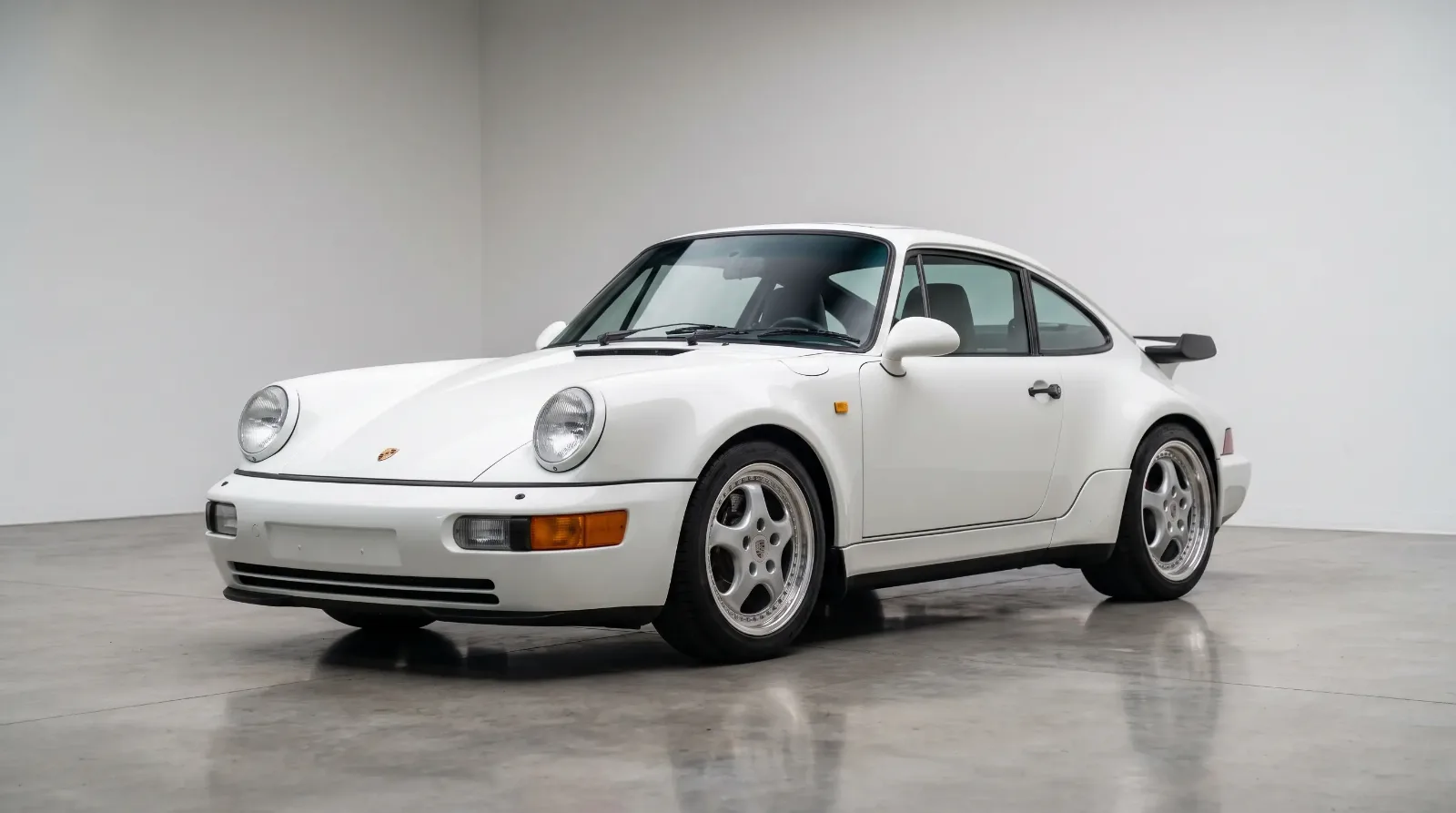 1992 Porsche 964 Turbo S Leichtbau in white, static three-quarter view in a minimalist showroom