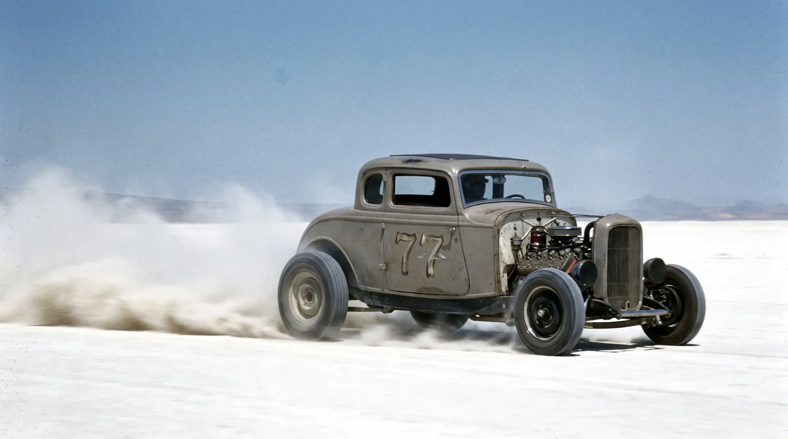 Stripped Ford Model B hot rod racing across dry lakebed