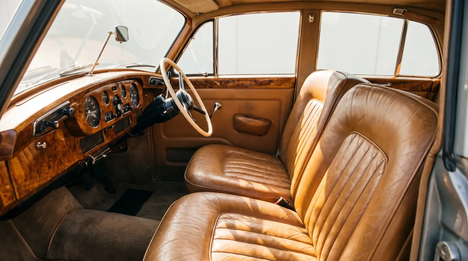 Restored 1960s Rolls-Royce Silver Cloud interior with Connolly leather seats and burl walnut dashboard veneer