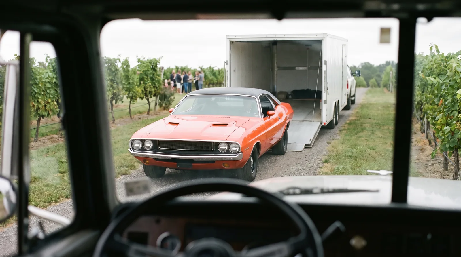 1970 Dodge Challenger R/T, beside an enclosed trailer on a vineyard lane