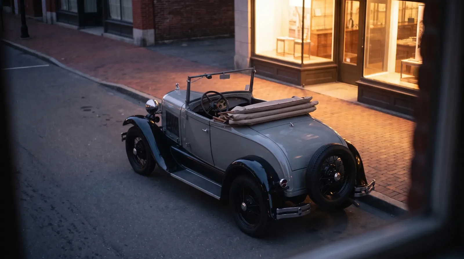 1928 Ford Model A Roadster, parked on a city street at dusk