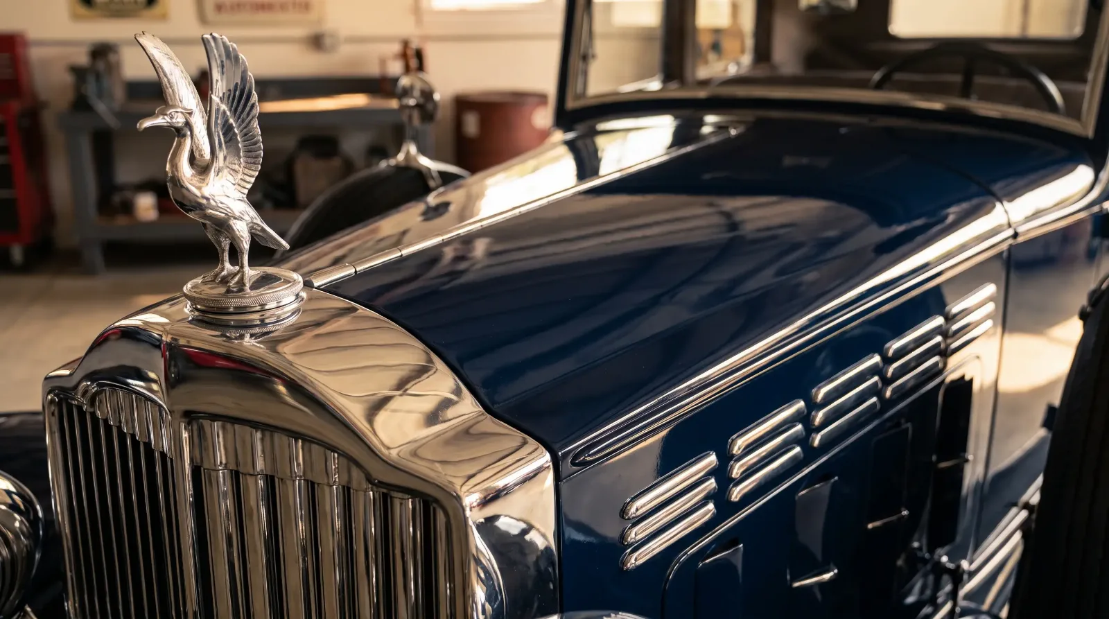 Close-up of a 1932 Packard Twelve's chrome radiator, hood ornament and hand-finished coachwork, the craftsmanship that defines a classic luxury car