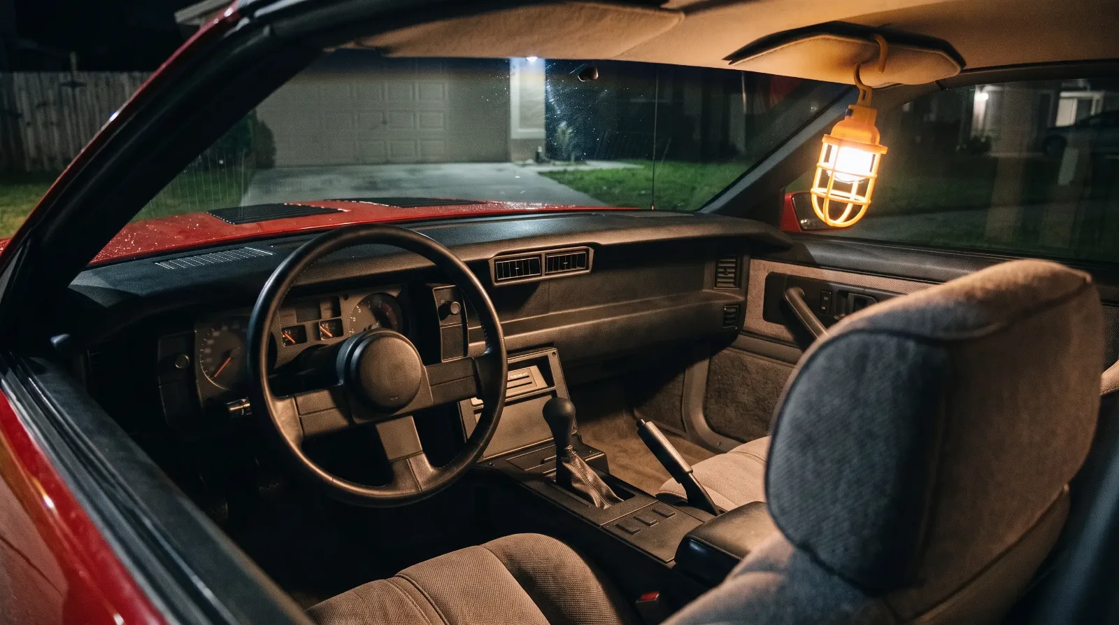1987 Chevrolet Camaro IROC-Z, cabin at night in a driveway