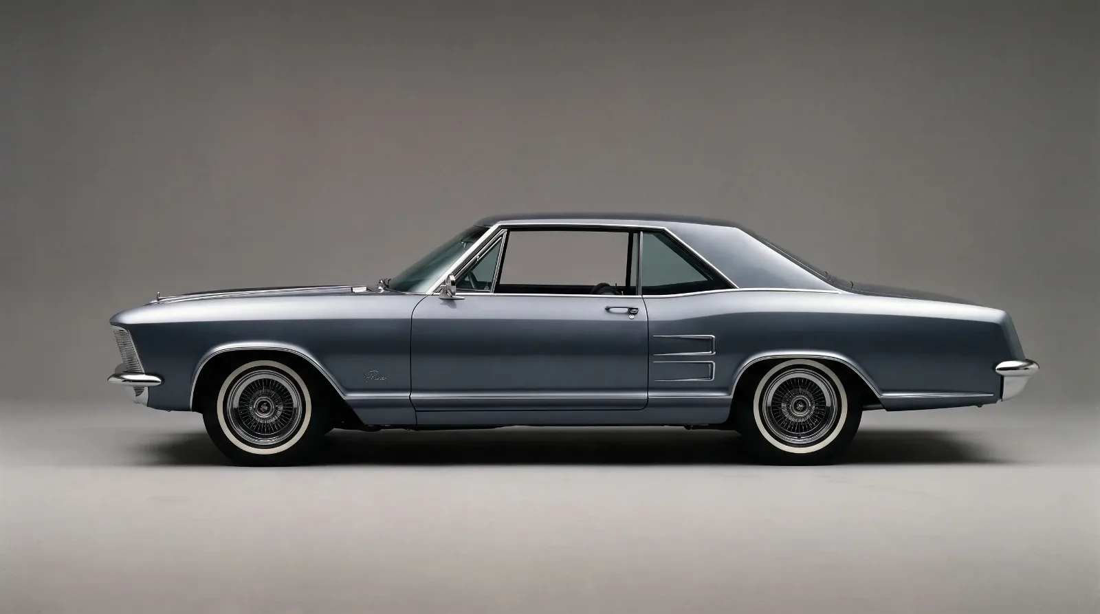 1963 Buick Riviera in side profile showing the long-hood, short-deck, formal-roof silhouette that defined the personal luxury coupe