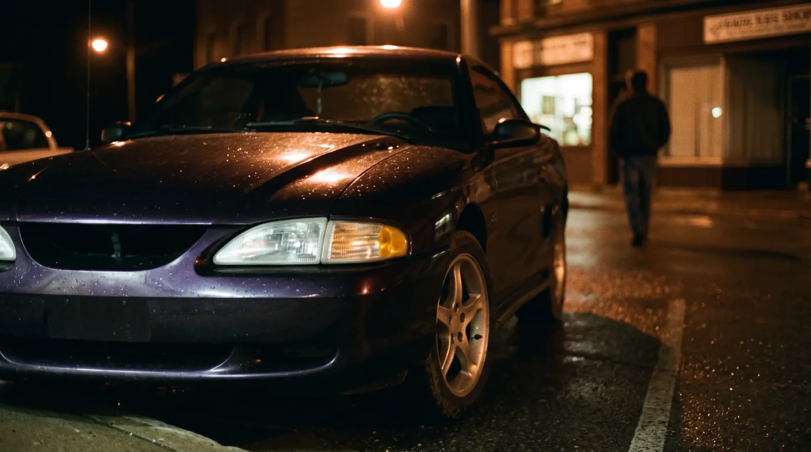 1997 Ford Mustang GT, parked on a town street at night