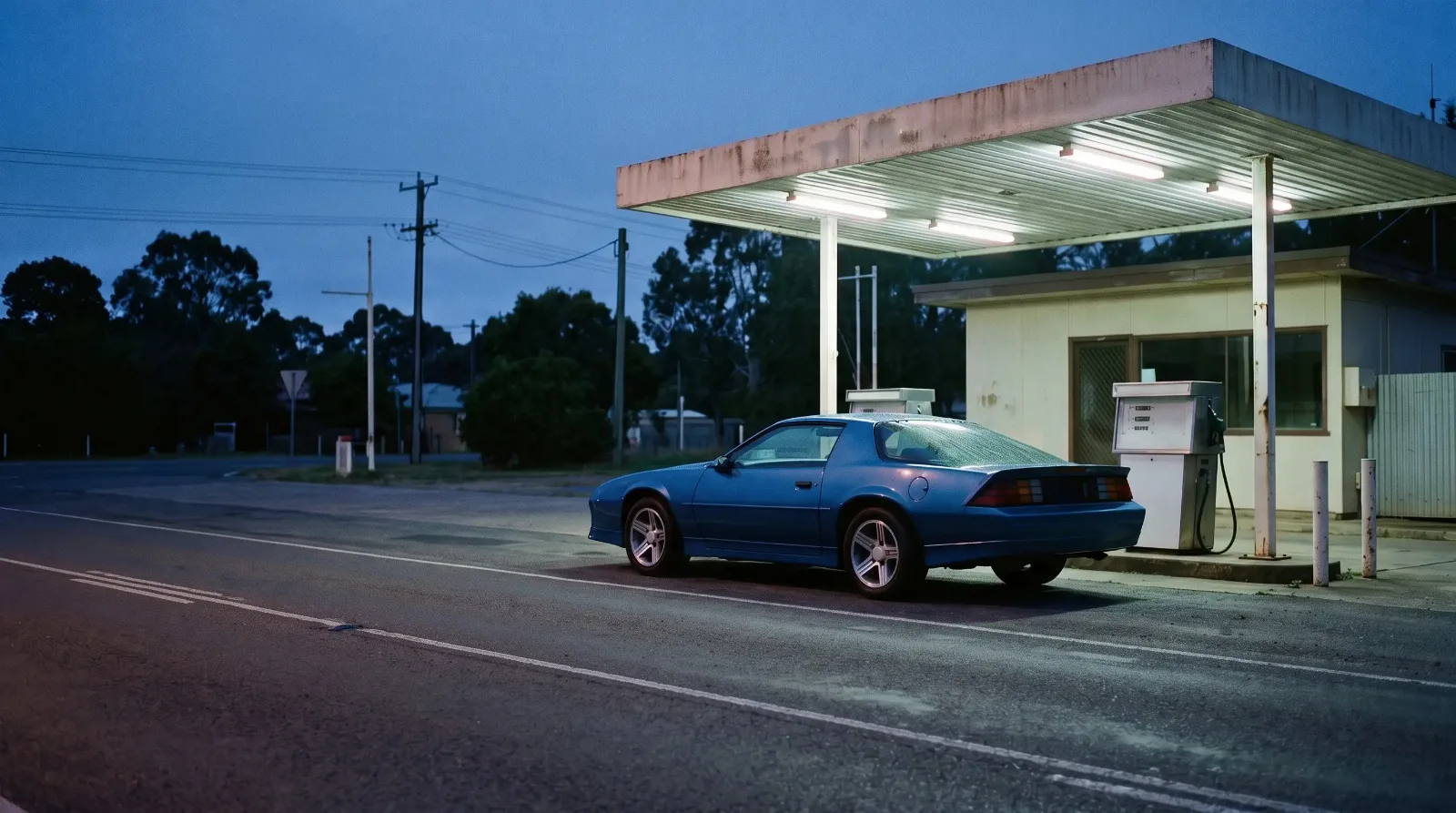 1988 Chevrolet Camaro IROC-Z, at a gas station at dusk