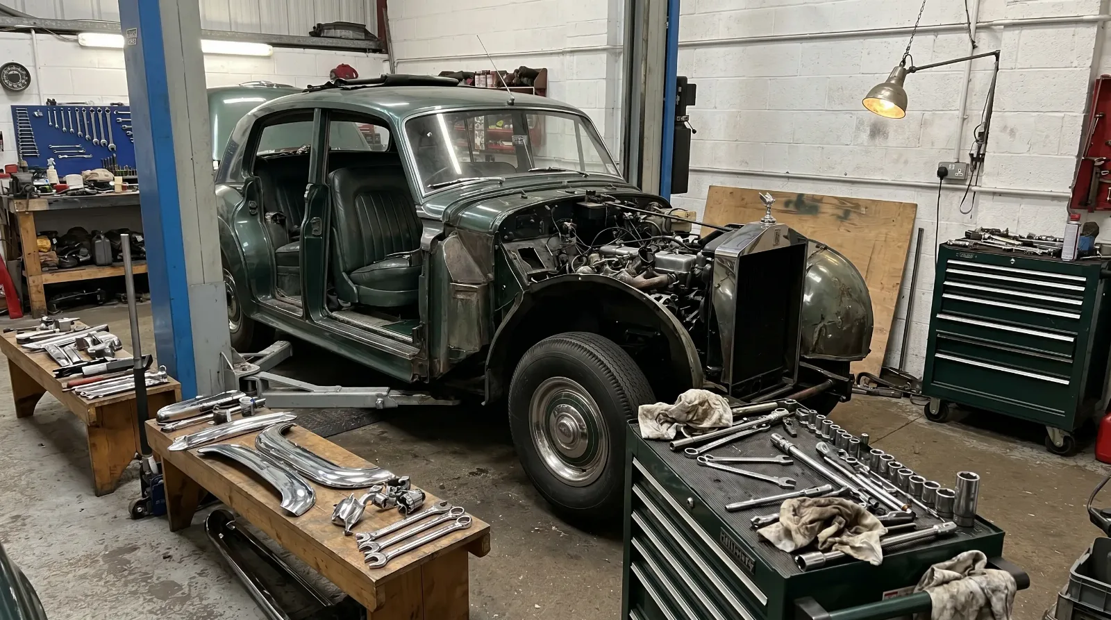 Classic luxury project car mid-restoration on a workshop lift