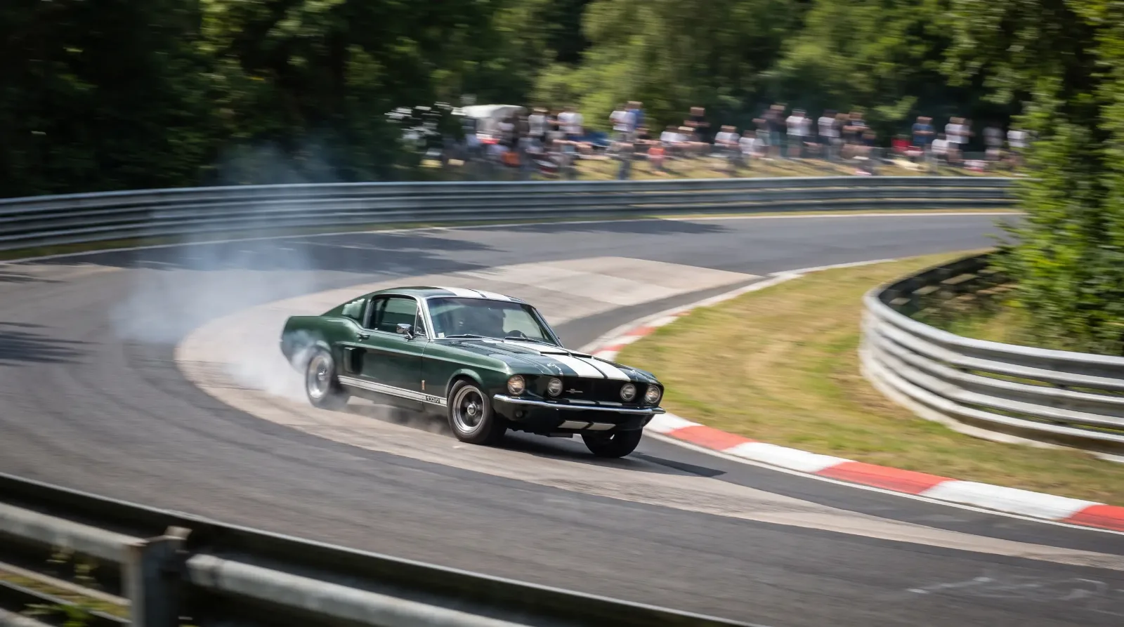 Classic Ford Mustang fastback cornering hard on a circuit