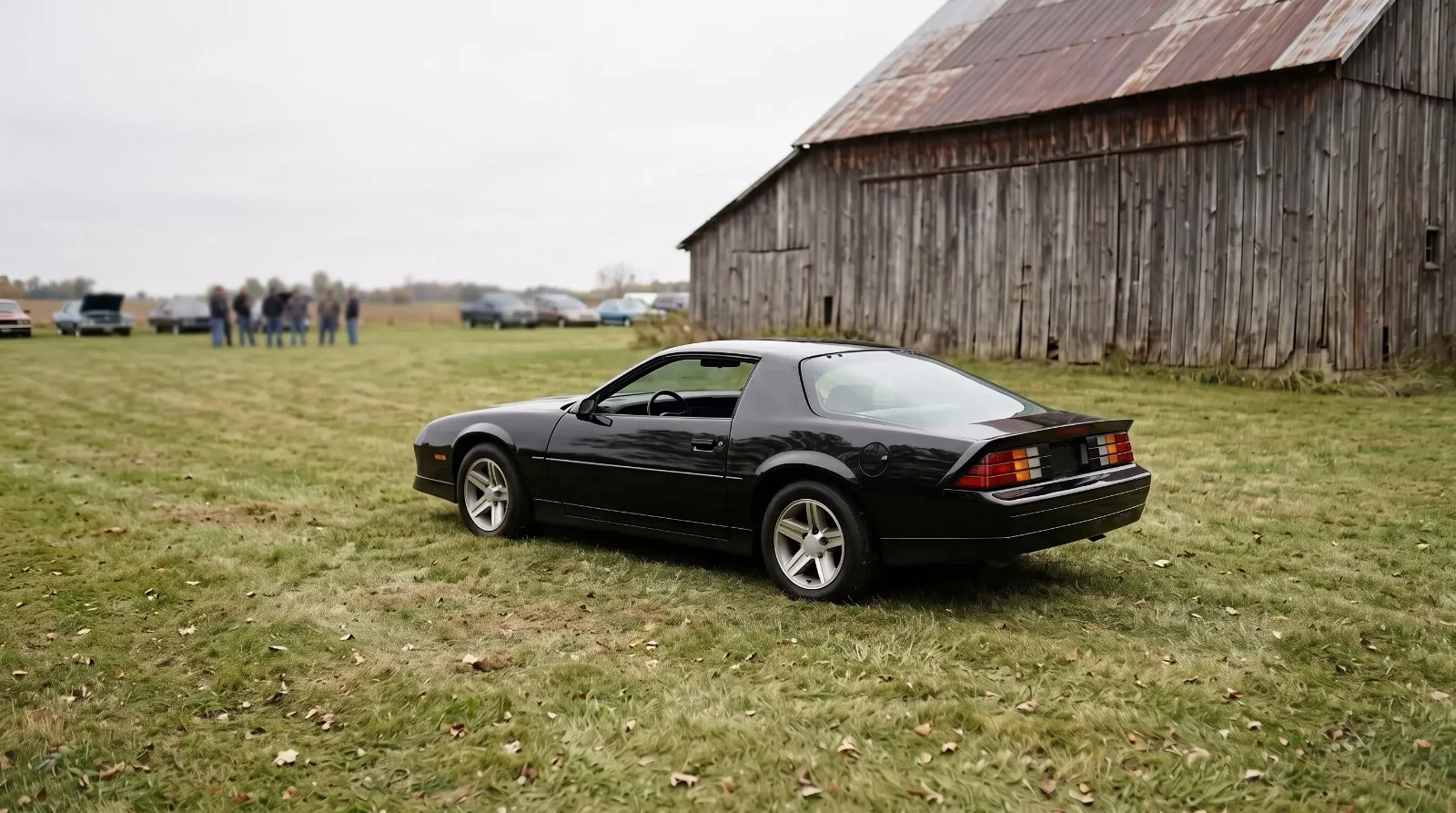 1987 Chevrolet Camaro IROC-Z, parked by a weathered barn